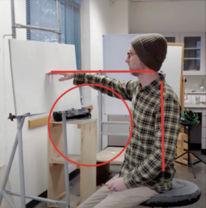 Artist painting with proper posture at an ergonomic workstation